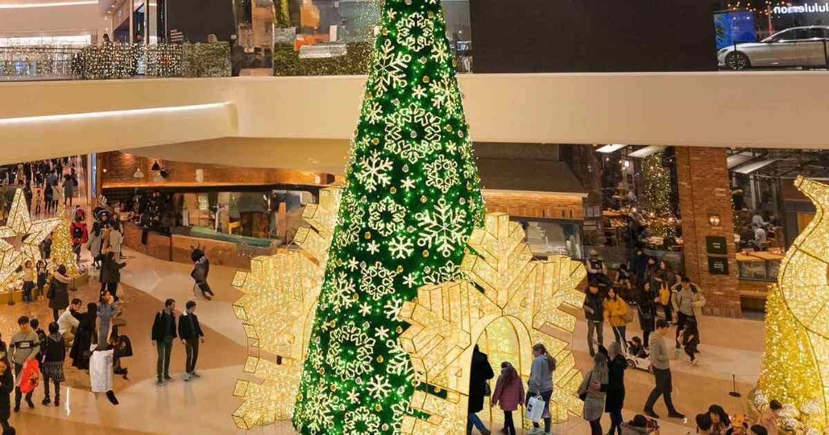 tall green walk through light tree display in mall 